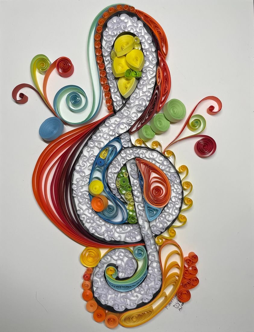 Holiday Card II: a paper card with a treble clef made of orange, red and blue quilled scrolls and white beads